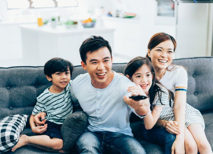 Family Watching TV Together and Enjoying Entertainment